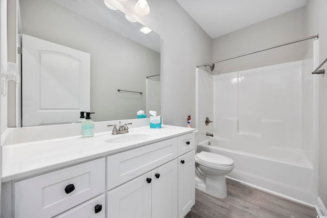 bathroom with vanity, shower / washtub combination, wood finished floors, and toilet