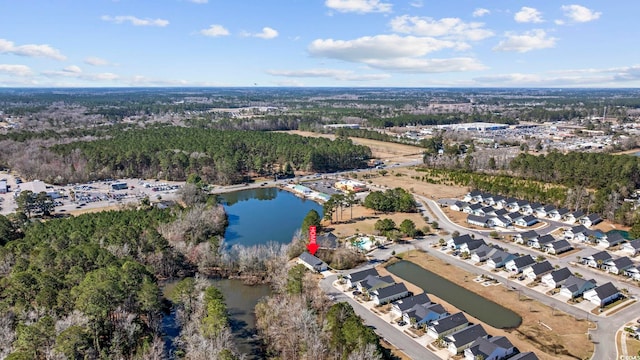 bird's eye view with a water view and a forest view