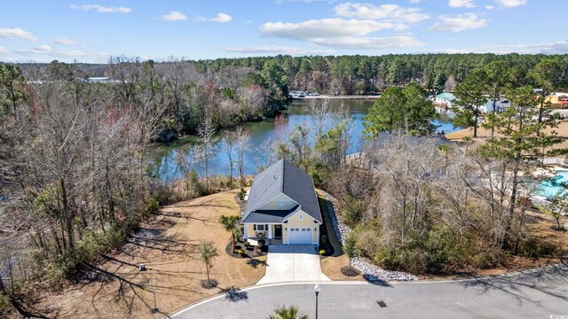 birds eye view of property featuring a water view and a forest view