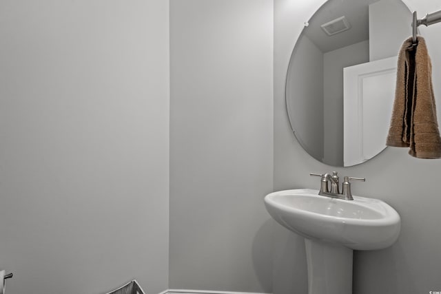 bathroom featuring visible vents and a sink