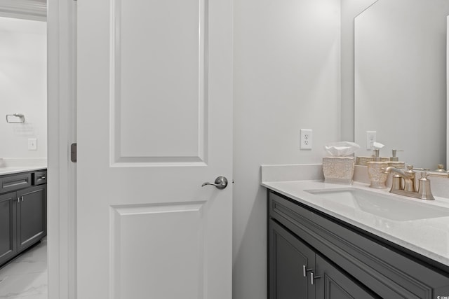 bathroom featuring marble finish floor and vanity