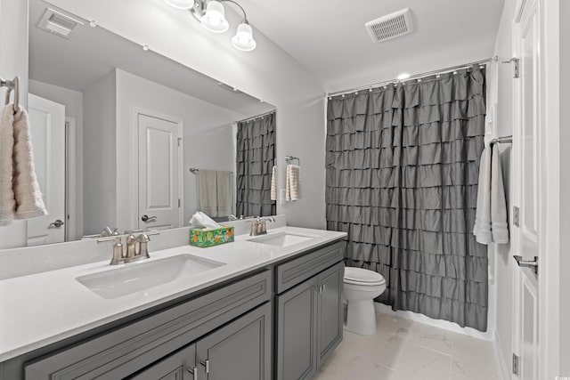 bathroom featuring visible vents, marble finish floor, toilet, and a sink