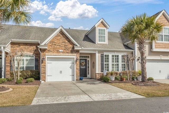 view of front of home with a garage, stone siding, roof with shingles, and driveway