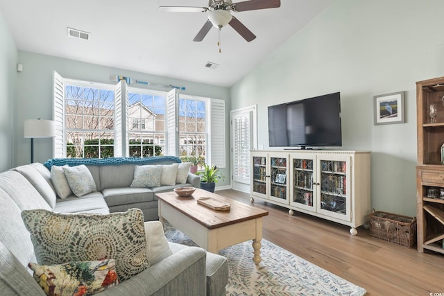 living room featuring visible vents, plenty of natural light, and wood finished floors