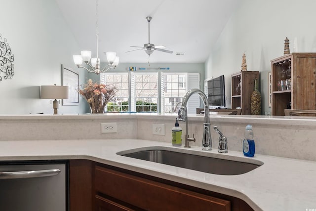 kitchen featuring lofted ceiling, dishwasher, light countertops, and a sink