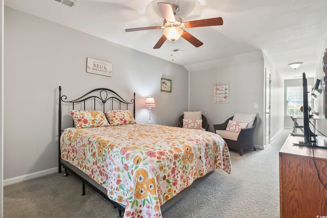 carpeted bedroom featuring vaulted ceiling, visible vents, ceiling fan, and baseboards