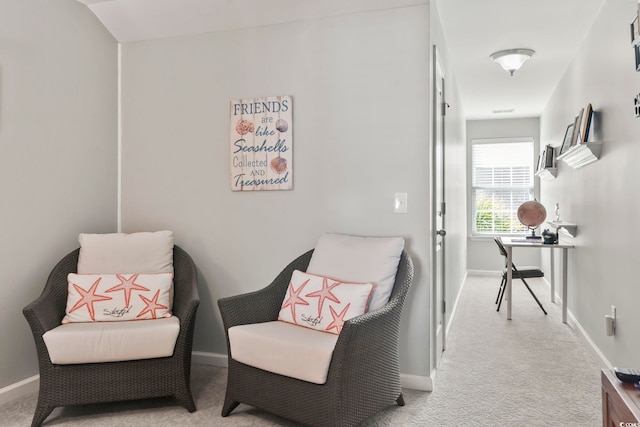 living area featuring carpet floors and baseboards