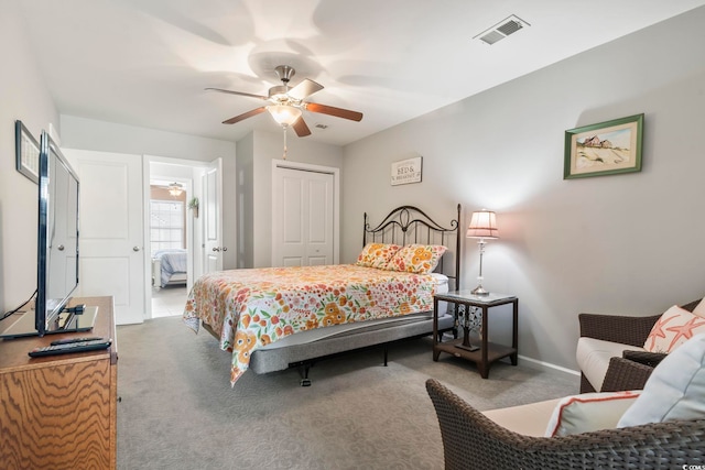 carpeted bedroom with a ceiling fan, a closet, visible vents, and baseboards