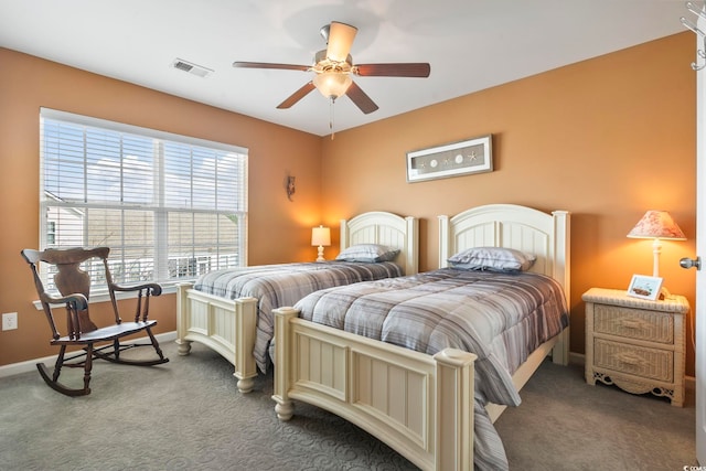 carpeted bedroom featuring ceiling fan, visible vents, and baseboards