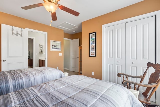 bedroom with a closet, attic access, and a ceiling fan