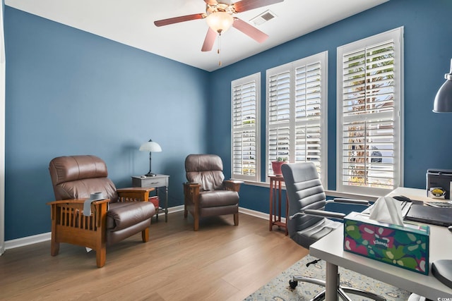 office space with baseboards, wood finished floors, visible vents, and a ceiling fan