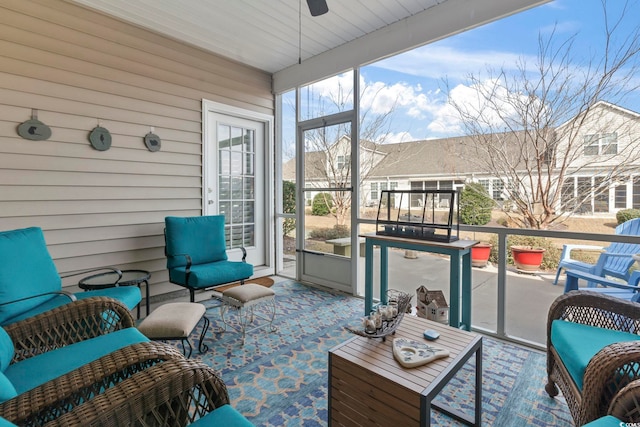 sunroom / solarium featuring a ceiling fan