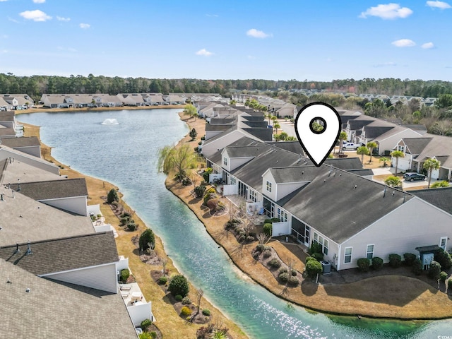 birds eye view of property featuring a water view and a residential view