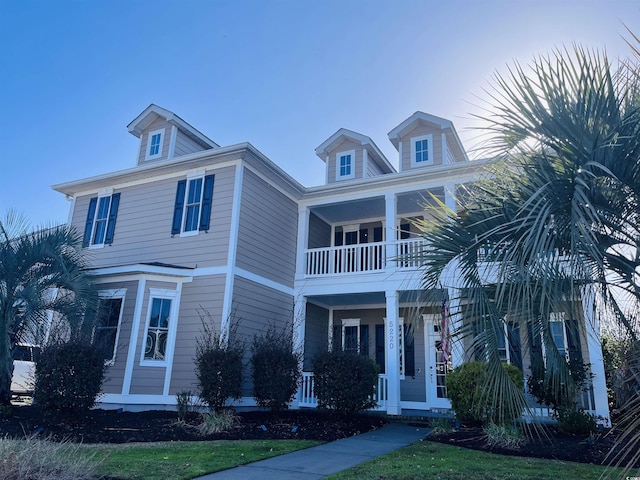 view of front facade featuring a balcony and covered porch