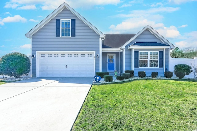 view of front facade featuring an attached garage, driveway, a front yard, and fence