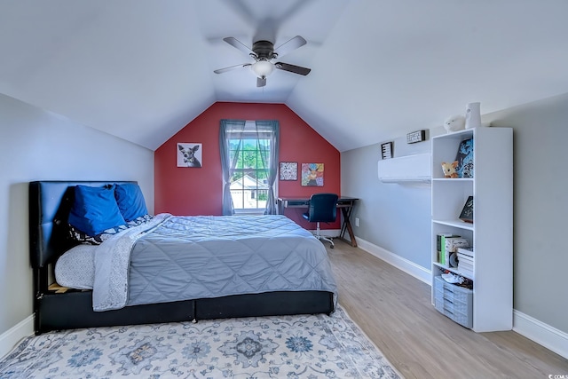 bedroom with lofted ceiling, ceiling fan, baseboards, and wood finished floors