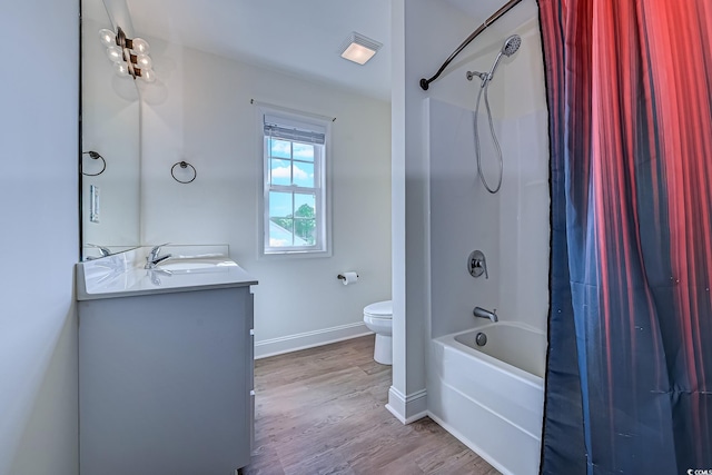 full bath featuring shower / bath combination with curtain, toilet, vanity, wood finished floors, and baseboards