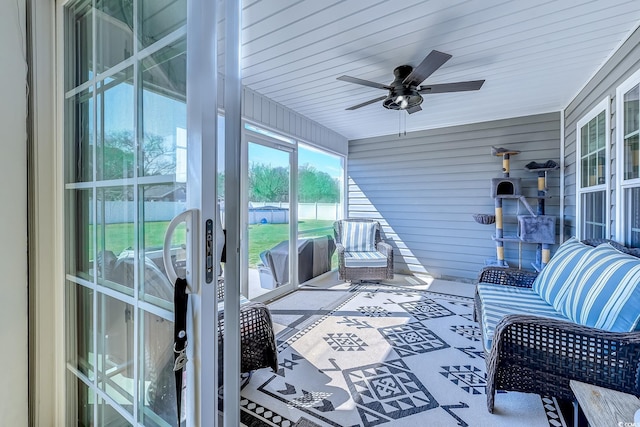 sunroom / solarium with a ceiling fan