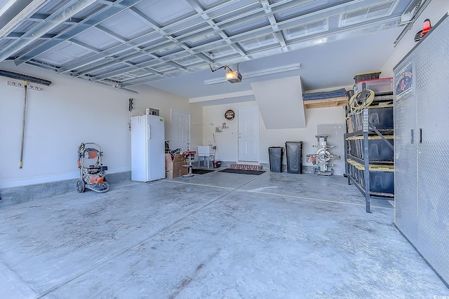 garage with a garage door opener and freestanding refrigerator