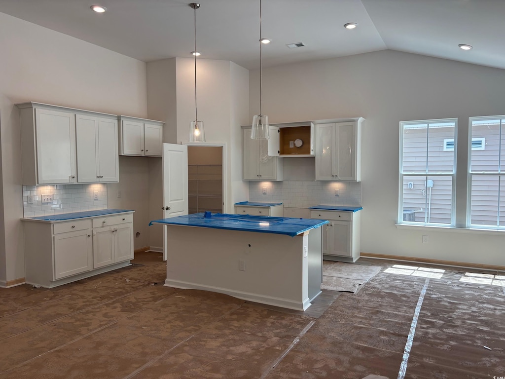 444 Sun Colony Blvd, Longs, SC 29568 - kitchen featuring a center island, backsplash, high vaulted ceiling, pendant lighting, and baseboards