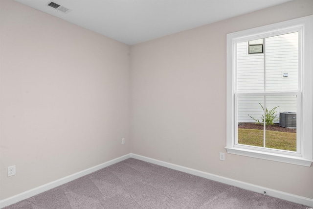 carpeted empty room with visible vents and baseboards