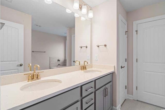 full bath featuring double vanity, a sink, visible vents, and tile patterned floors