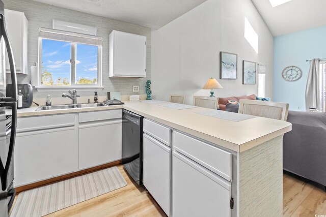 1890 Colony Dr Unit 17T, Surfside Beach, SC 29575 - kitchen with a sink, light wood-style floors, black dishwasher, a peninsula, and open floor plan