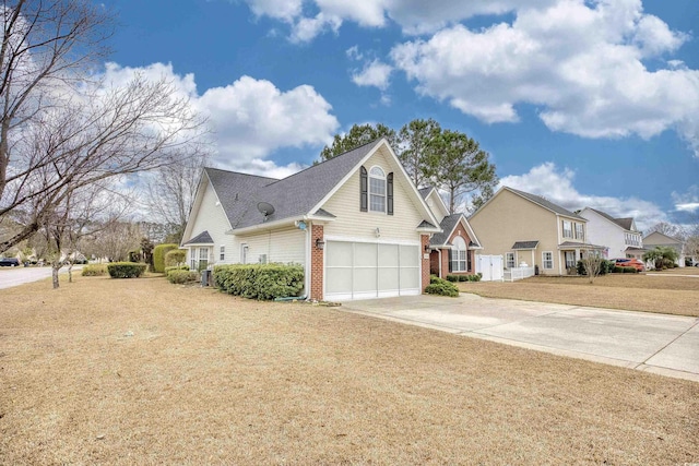 view of home's exterior featuring driveway, an attached garage, a lawn, and brick siding