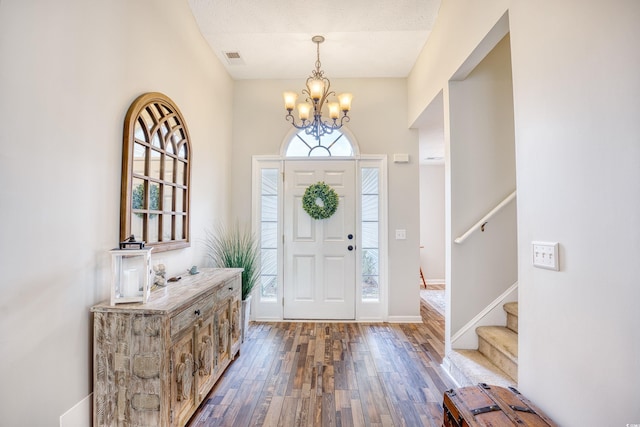 3736 Brookhill Dr, Myrtle Beach, SC 29588 - entryway with healthy amount of natural light, dark wood-style floors, a chandelier, and stairway