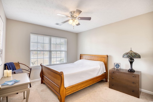 bedroom with visible vents, carpet flooring, ceiling fan, a textured ceiling, and baseboards