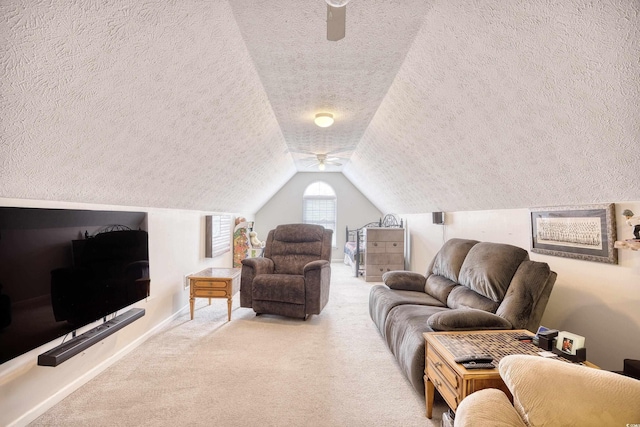 carpeted living area with lofted ceiling, a textured ceiling, and baseboards