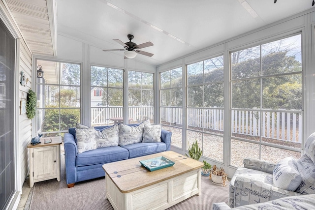 sunroom with a ceiling fan, lofted ceiling, and plenty of natural light