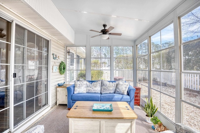 sunroom with lofted ceiling and a ceiling fan