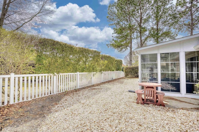 view of yard with a fenced backyard and a sunroom