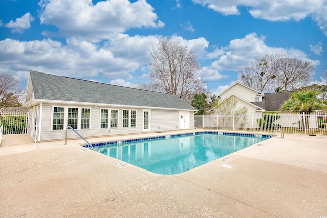 pool with fence and a patio