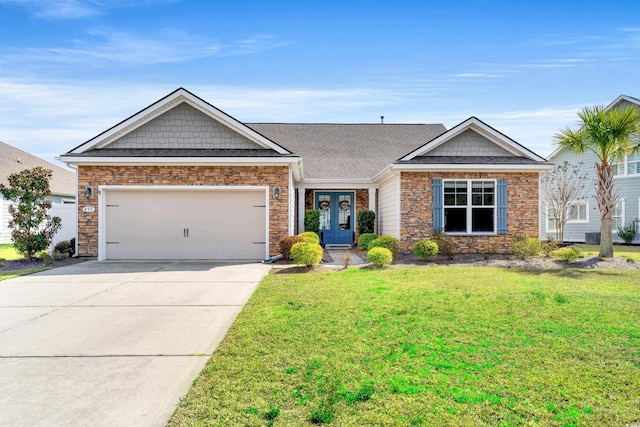 view of front of home featuring roof with shingles, an attached garage, a front lawn, concrete driveway, and stone siding