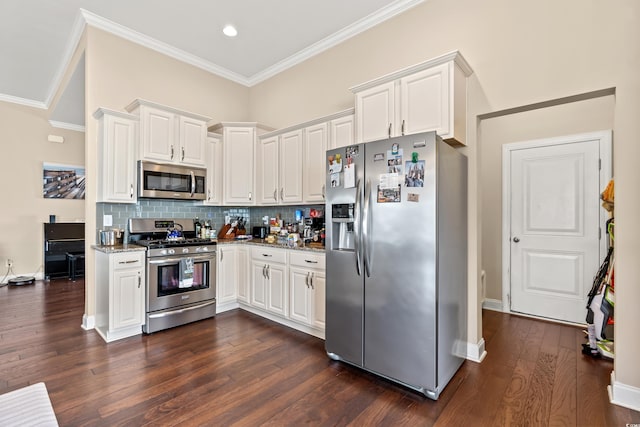 kitchen featuring white cabinetry, crown molding, backsplash, and appliances with stainless steel finishes