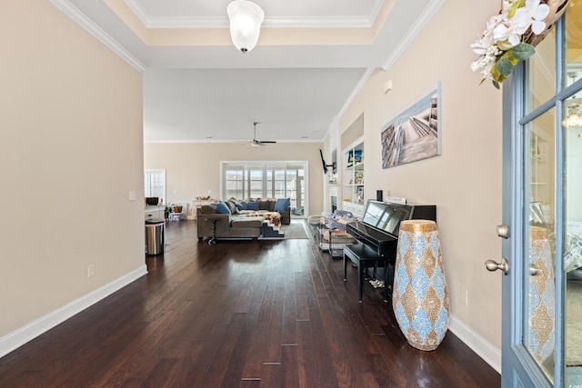 living room with wood-type flooring, ornamental molding, and a ceiling fan