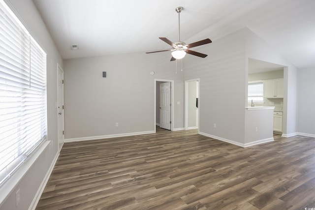 unfurnished living room featuring high vaulted ceiling, baseboards, dark wood finished floors, and a ceiling fan