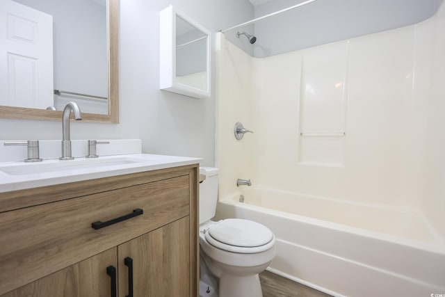 bathroom featuring wood finished floors, vanity, toilet, and shower / bathtub combination