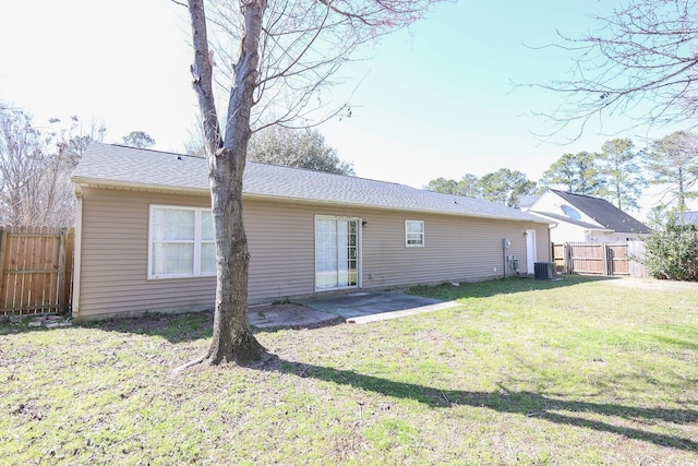 back of house featuring central AC, a lawn, a patio, and fence