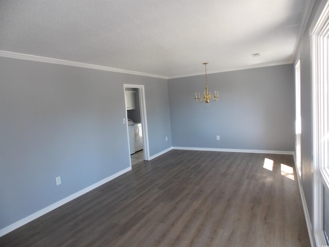 empty room featuring dark wood-style floors, independent washer and dryer, baseboards, and ornamental molding