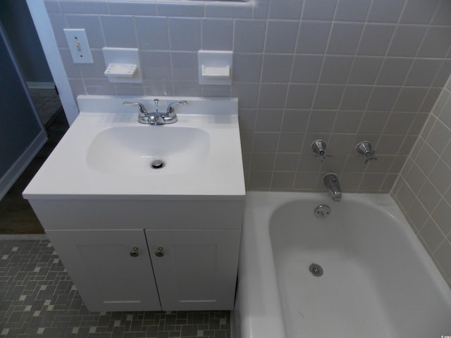 full bathroom featuring vanity and a bath