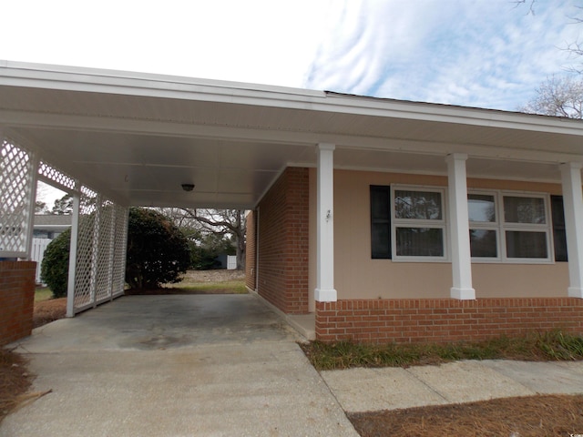 view of car parking with an attached carport and concrete driveway