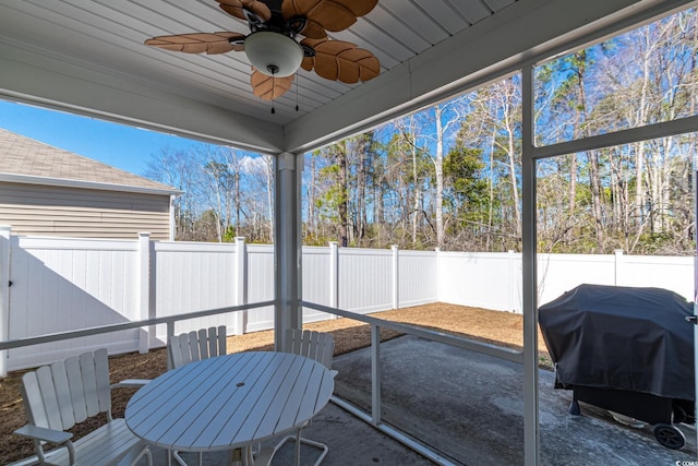 sunroom / solarium with a ceiling fan and a healthy amount of sunlight