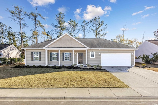 view of front of home with a front lawn, concrete driveway, a garage, and roof with shingles