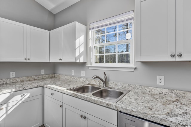 kitchen featuring a sink, white cabinets, and light countertops