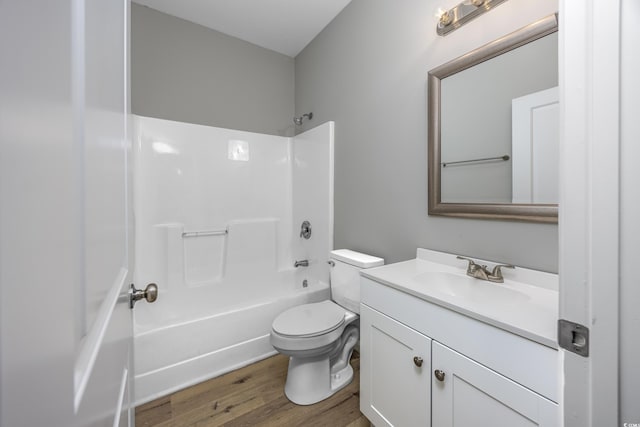 bathroom with vanity, shower / bathing tub combination, toilet, and wood finished floors