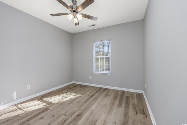 spare room with visible vents, baseboards, light wood-style floors, and ceiling fan