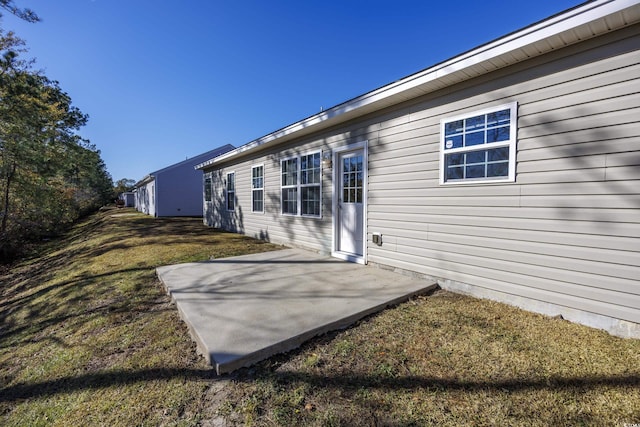 exterior space featuring a patio area and a lawn